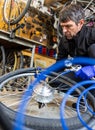 Cycle mechanist working on bike tires in workshop