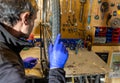 Cycle mechanist working on spokes on wheel in workshop