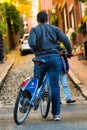 Cycling tourist driving at one of Boston iconic street at Beacon Hill, Boston, vertical shot