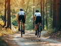 Cycling. two people with bicycle on a park road on a spring day Royalty Free Stock Photo