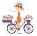 Pretty young cycling woman with bouquets of flowers in the baskets