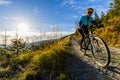 Cycling woman riding on bike in autumn forest landscape. Woman cycling MTB flow trail track. Outdoor sport activity