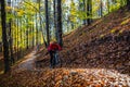 Cycling woman riding on bike in autumn forest landscape. Woman cycling MTB flow trail track. Outdoor sport activity