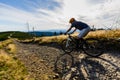 Cycling woman riding on bike in autumn forest landscape. Woman cycling MTB flow trail track. Outdoor sport activity