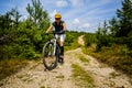 Cycling woman riding on bike in autumn forest landscape. Woman cycling MTB flow trail track. Outdoor sport activity Royalty Free Stock Photo