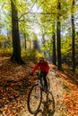 Cycling woman riding on bike in autumn.
