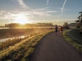 Cycling young son accompanying his mother on a early morning run Royalty Free Stock Photo