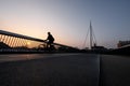 Cyclist on a bicycle bridge in Odense, Denmark