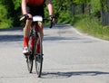 cyclist with bike rides fast on the asphalt road Royalty Free Stock Photo