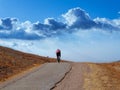 A cyclist biking on a golden hill in northern California