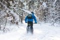 Cyclist in Blue Drifting on Mountain Bike in Beautiful Winter Forest. Extreme Sport and Enduro Biking Concept. Royalty Free Stock Photo