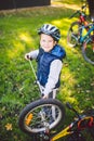 Cyclist boy Bike repair. little boy fixing his bike. Children mechanics, bicycle repair profession. Learning about cycles and Royalty Free Stock Photo