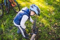 Cyclist boy Bike repair. little boy fixing his bike. Children mechanics, bicycle repair profession. Learning about cycles and Royalty Free Stock Photo