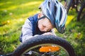 Cyclist boy Bike repair. little boy fixing his bike. Children mechanics, bicycle repair profession. Learning about cycles and Royalty Free Stock Photo