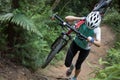 Cyclist carry a mountain bike in the forest