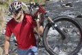 Cyclist Carrying Bike In River Royalty Free Stock Photo