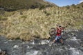 Cyclist Carrying Bike In River Royalty Free Stock Photo