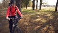 Cyclist. Caucasian sport woman rides along the track in the forest on a spring sunny day. Riding a sportsman girl on a Royalty Free Stock Photo