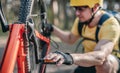 Cyclist checking chainwheel defect Royalty Free Stock Photo