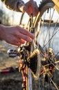 Cyclist checks the bike chain after driving in the park.