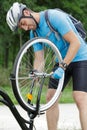 cyclist checks bike chain in park