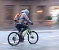 Cyclist on the city roadway on a rainy day in motion blur Royalty Free Stock Photo