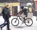 Cyclist on the city roadway on snowy day in motion blur Royalty Free Stock Photo