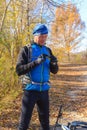 Cyclist cleans glasses during rest. Active man rides a bike in t