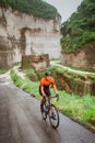 cyclist climbing up elevated road using his road bike