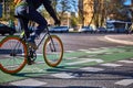 A cyclist crosses a crossroads along a bicycle path. Eco-friendly mode of transport