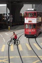 Cyclist crossing tram tracks in Hong Kong