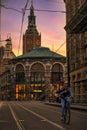 Cyclist cycling in front of The Great Church, Grote Kerk in Dutch in The Hague during the sunset