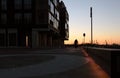 Cyclist cycling in front of a nightly skyline at modern Kalamaja district in Tallinn city, port area