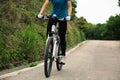 Women cyclist cycling mountain bike on forest trail Royalty Free Stock Photo