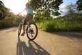 Cyclist cycling on sunrise forest trail