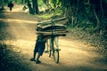 Cyclist on Dirt Road in the jungle. Cambodia