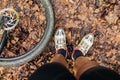 Cyclist dirty legs and wheel of a mountain bike Royalty Free Stock Photo