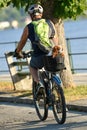 A cyclist with a dog in the back seat