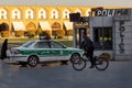 A cyclist drives past an iranian police car near the police station