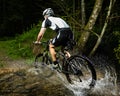 An cyclist is driving through water Royalty Free Stock Photo