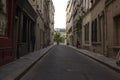 Cyclist at the end of a street on Ile Saint Louis, Paris