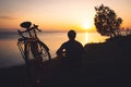Cyclist enjoy panoramic view of lake outdoors on sunset. Healthy lifestyle and bicycle touring. Ecological travel