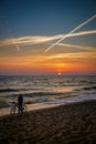 A cyclist enjoying the sea's breathtaking sunset