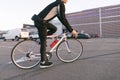 Cyclist on a fast-paced bike ride, ride in the parking lot, on the background of the mall