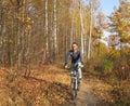 Cyclist in the forest park, golden autumn in nature Royalty Free Stock Photo