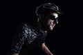 Cyclist in front of a dark background