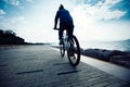 cyclist getting on bike in the sunrise coast road