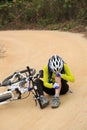 Cyclist getting injured while falling from mountain bike Royalty Free Stock Photo