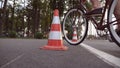 Cyclist go round traffic cones. Young handsome man riding a vintage bicycle. Sporty guy cycling at the park. Healthy Royalty Free Stock Photo