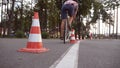 Cyclist go round traffic cones. Young handsome man riding a vintage bicycle. Sporty guy cycling at the park. Healthy Royalty Free Stock Photo